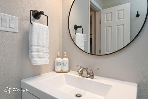 a bathroom with a sink and a mirror at Rex Ranch Comfortable and Close to Everthing in Abilene