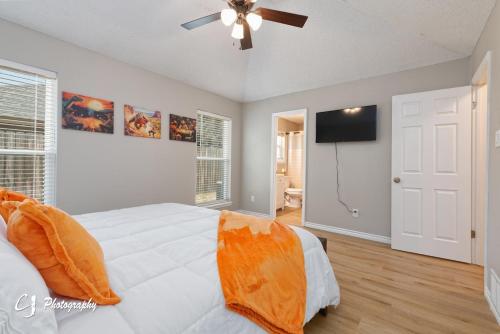 a bedroom with a white bed and a ceiling fan at Rex Ranch Comfortable and Close to Everthing in Abilene