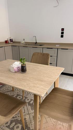 a wooden table with a potted plant on it in a kitchen at نزل الجادية in Al Baha