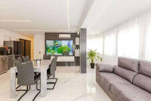 a living room with a couch and a table and a television at Azure Bliss in Costa de Adeje