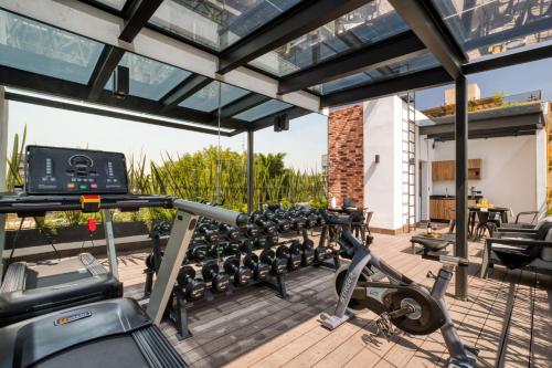 a gym with cardio equipment on the deck of a house at ULIV Roma Norte in Mexico City