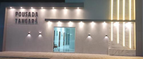 a building with a door with lights on it at Pousada Tangará 