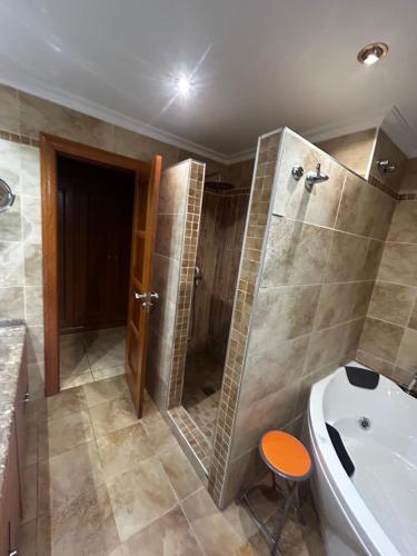 a bathroom with a shower and a tub and a toilet at Casa Rural Quemadas AnayMiguel in Córdoba