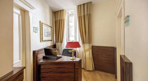 a room with a desk with a laptop computer on it at 939 Hotel in Rome