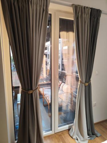a pair of curtains in front of a window at Sky view N&N in Skopje