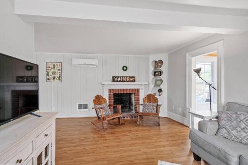a living room with a couch and a fireplace at Charming Kennebunk Cape - Walk to Dock Square! in Kennebunkport