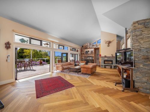 a large living room with a large stone fireplace at The View at Kerikeri Inlet in Kerikeri