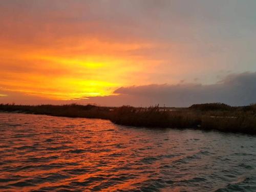 a sunset over a body of water with the sun setting at 6 person holiday home in Dannemare-By Traum in Dannemare