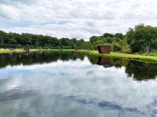 a body of water with a bridge and trees at 6 person holiday home in Hovborg-By Traum in Hovborg