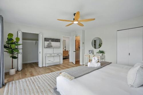 a white bedroom with a bed and a ceiling fan at Solana Gem - Need to add in Solana Beach