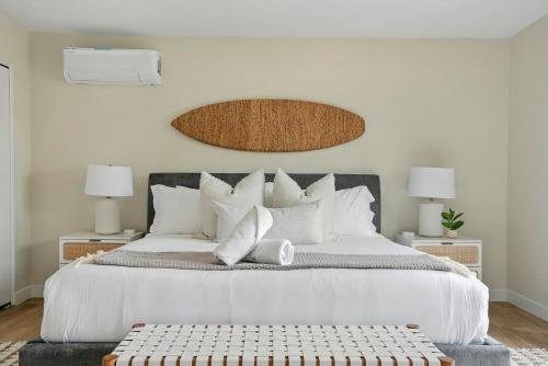 a bedroom with a large white bed with white pillows at Solana Gem - Need to add in Solana Beach