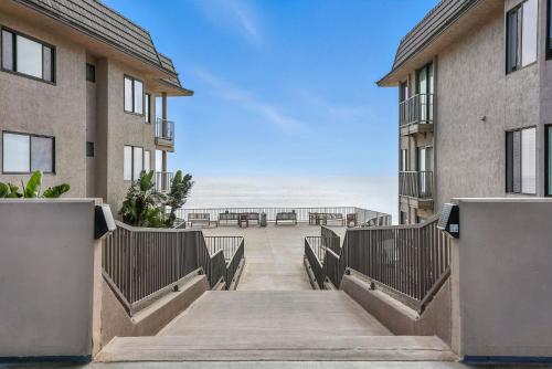 a stairway leading to the beach between two buildings at Solana Gem - Need to add in Solana Beach