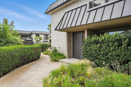 a house with a walkway next to a building at Solana Gem - Need to add in Solana Beach