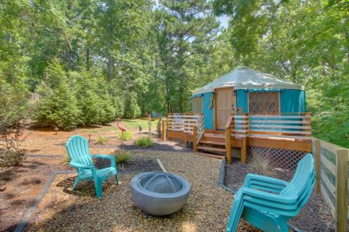 a gazebo with two chairs and a fire pit at Unplugged Retreat! Unique Yurt with Deck in Smokies in Smithville