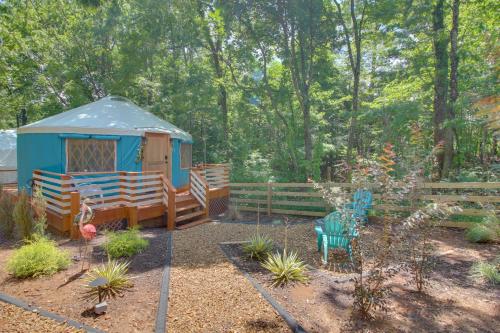 a gazebo with a table and chairs in a garden at Unplugged Retreat! Unique Yurt with Deck in Smokies in Smithville