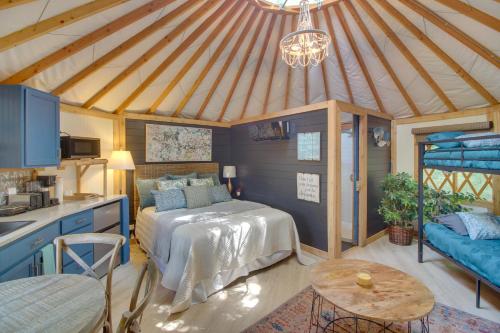 a bedroom with a bed and a table in a room at Unplugged Retreat! Unique Yurt with Deck in Smokies in Smithville