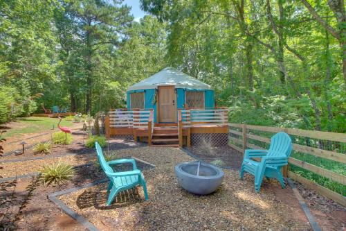 a gazebo with two chairs and a fire pit at Unplugged Retreat! Unique Yurt with Deck in Smokies in Smithville