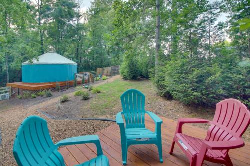 three chairs sitting on a deck with a gazebo at Unplugged Retreat! Unique Yurt with Deck in Smokies in Smithville
