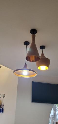three lights hanging from the ceiling in a room at Caribean Seascape in Villas del Mar