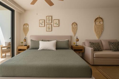 a bedroom with a bed and a couch at New Luxury Studio in the City Center in Playa del Carmen