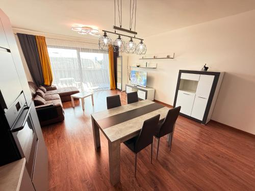 a living room with a dining room table and chairs at Y&Y apartments in Bratislava