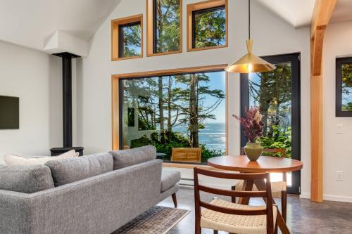 a living room with a couch and a table at Fogged Inn in Ucluelet