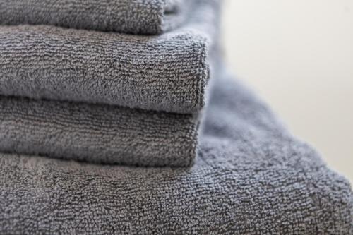 a pile of gray towels stacked on top of each other at St James Court Aparthotel in Derby