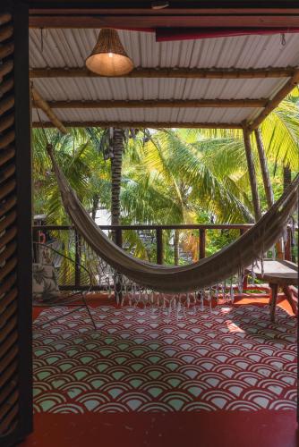 a hammock on the porch of a resort at Isla Fuerte Eco House in Isla Fuerte