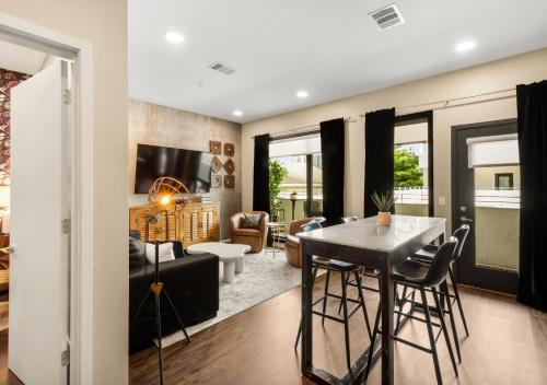 a kitchen and living room with a table and chairs at King Bed,Steps To Broadway,Park Free, No Fees in Nashville