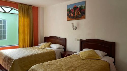 Una cama o camas en una habitación de Grand Río Hotel ec