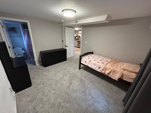 a bedroom with a bed and a tv in it at Basement Unit 2br 2ba in Barnum West Near Belmar and Sloan Lake 10 mins to Downtown in Denver