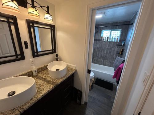 a bathroom with a sink and a toilet and a tub at Basement Unit 2br 2ba in Barnum West Near Belmar and Sloan Lake 10 mins to Downtown in Denver
