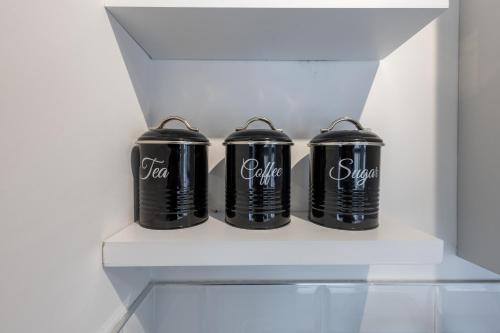 three black canisters in a refrigerator drawer at St James Court Aparthotel in Derby