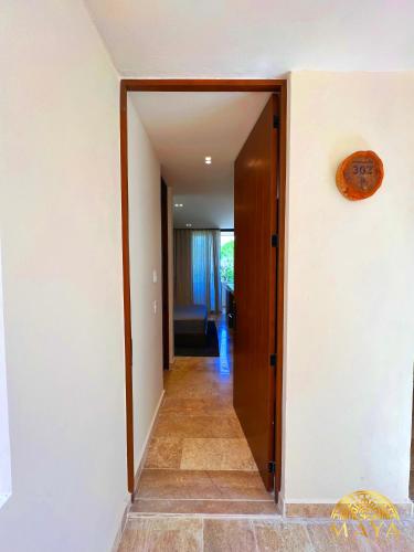 a hallway with a door leading into a room at Peregrina Tulum Lux Aparthotel in Tulum
