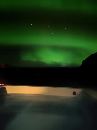an image of the green northern lights in the sky at Sky Retreat & Private Jacuzzi in Hvolsvöllur