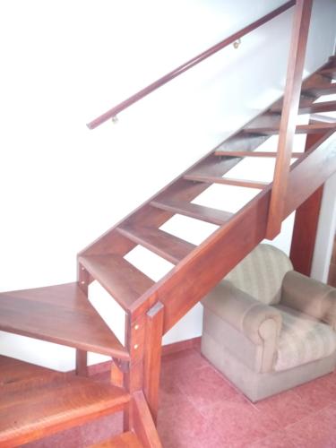 a loft bed with a desk and a chair at Babella in Concordia