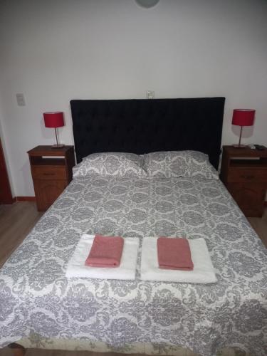 a bedroom with a bed with two towels on it at Babella in Concordia