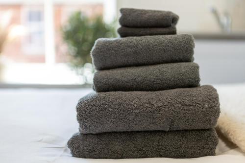 a stack of towels sitting on a table at St James Court Aparthotel in Derby