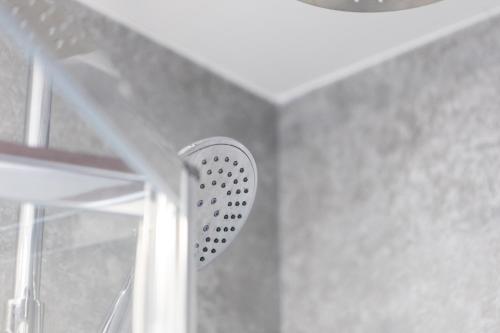 a shower head in a bathroom with a window at St James Court Aparthotel in Derby