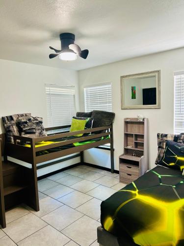 a bedroom with two beds and a ceiling fan at The Greenhouse Effect in Corpus Christi