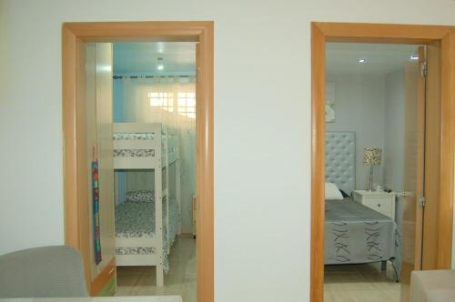 a room with two bunk beds and a mirror at casa vacacional con piscina privada in Sant Cebrià de Vallalta