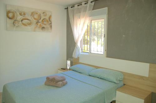 a bedroom with a bed with a towel on it at casa vacacional con piscina privada in Sant Cebrià de Vallalta