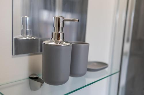 a bathroom sink with a faucet on a counter at St James Court Aparthotel in Derby