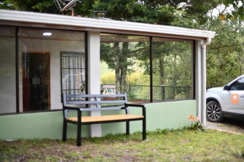 a bench sitting in front of a house at Fergust Family Studio Monteverde in Sierra