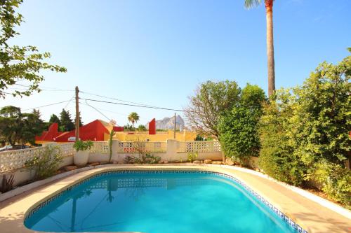 a swimming pool in a yard with a fence at Chalet Carrio Park 5B in Casas de Torrat
