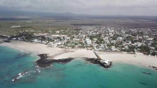 an aerial view of a beach with a city at Isla Sol Boutique in Puerto Villamil