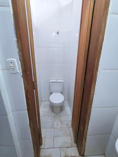 a small bathroom with a toilet in a stall at Hospedaria 33 in Barretos