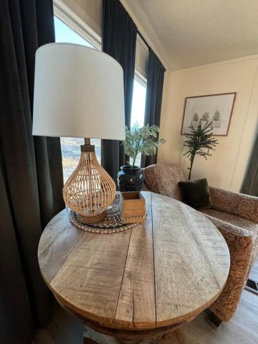 a table with a lamp on it in a living room at Scenic Ranch Retreat Near Fresno in Fresno