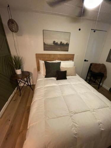 a large white bed in a room with a table at Scenic Ranch Retreat Near Fresno in Fresno