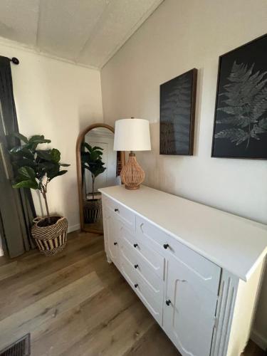 a white dresser with a lamp on top of it at Scenic Ranch Retreat Near Fresno in Fresno